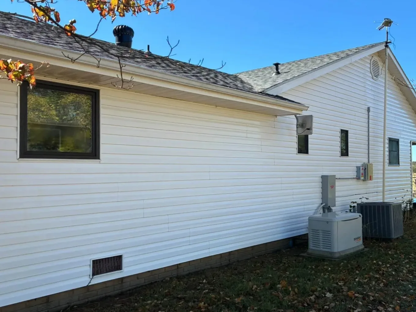 The same white siding after washing, clean and bright
